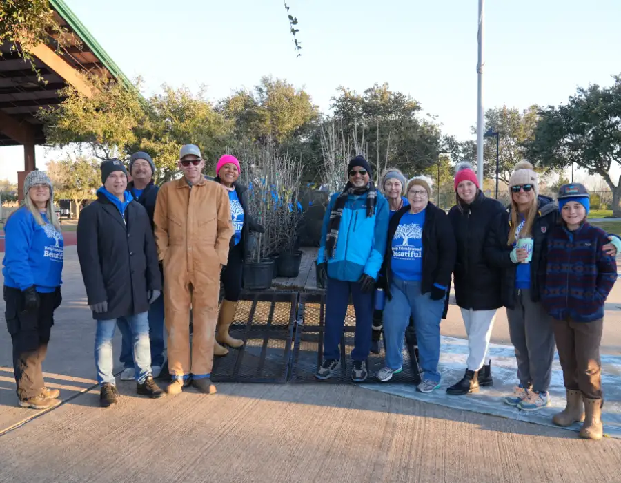Friendswood tree giveaway volunteers in front of trees.